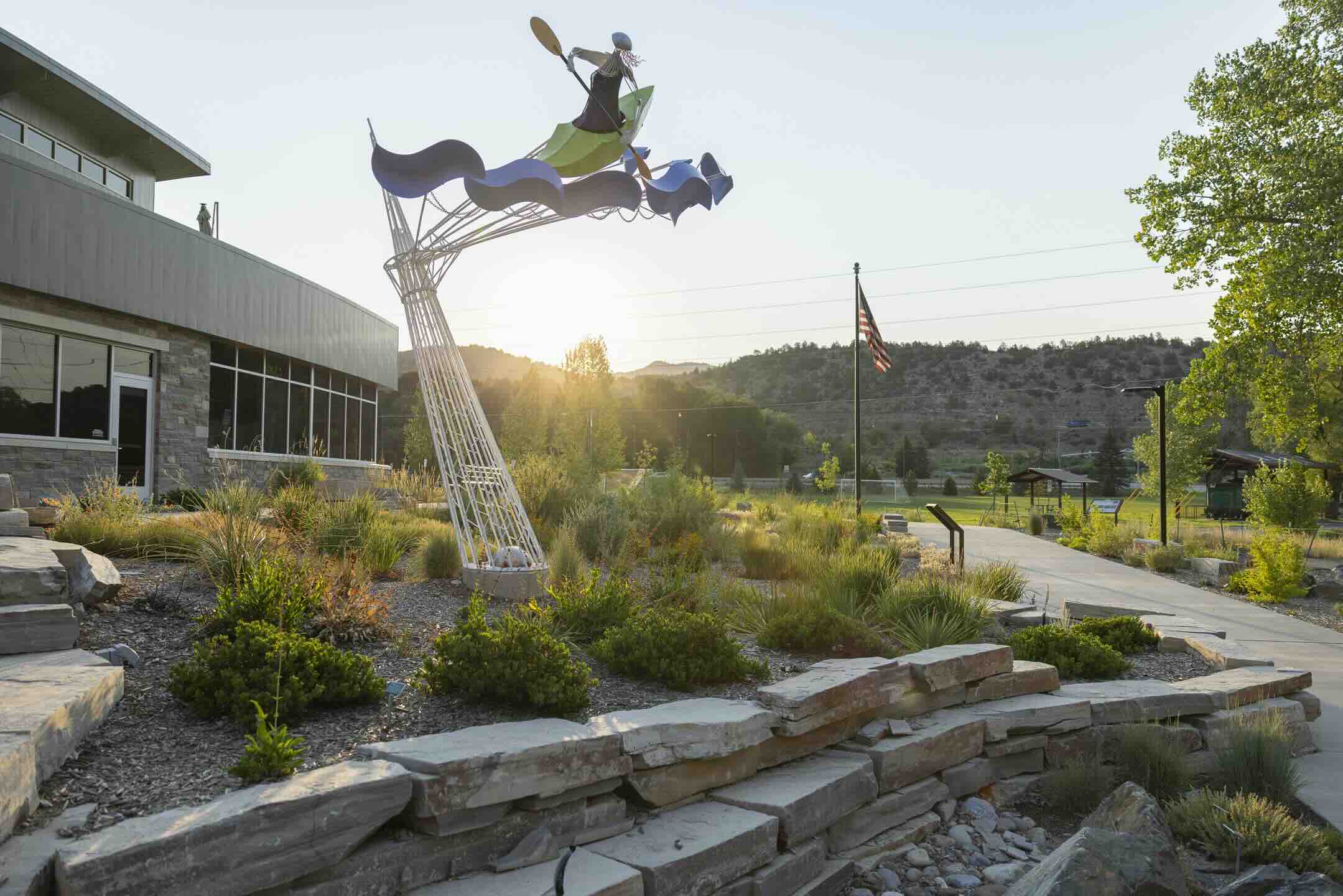Kayaker sculpture rising above a xeric rain garden at Santa Rita Water Reclamation Facility in Durango