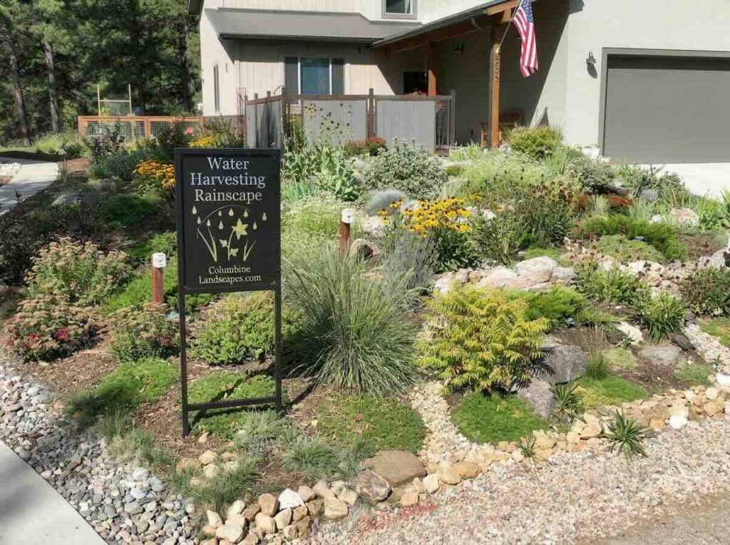 A house and rain garden in Durango, Colorado, with a Durango's Living Rainscapes tour sign, one of nine properties on the self-guided tour